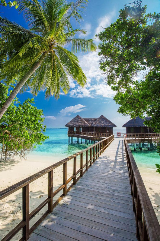 Bridge leading to overwater bungalow in blue lagoon Wall Decal