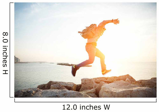brave man running over rocks near ocean in beautiful sunset Wall Decal