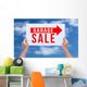 Two hands holding brown cardboard with garage sale on blue sky b Wall Decal