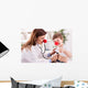 Smiling doctor examining success child with finger up Wall Decal