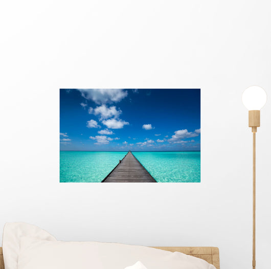 Wooden pier with blue sea and sky background Wall Decal