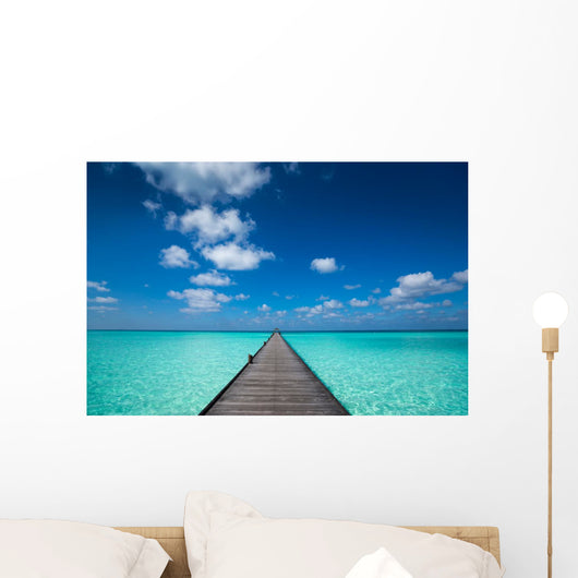 Wooden pier with blue sea and sky background Wall Decal