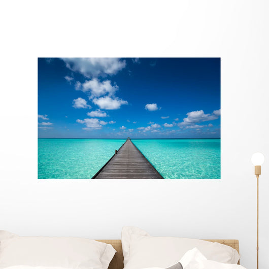 Wooden pier with blue sea and sky background Wall Decal