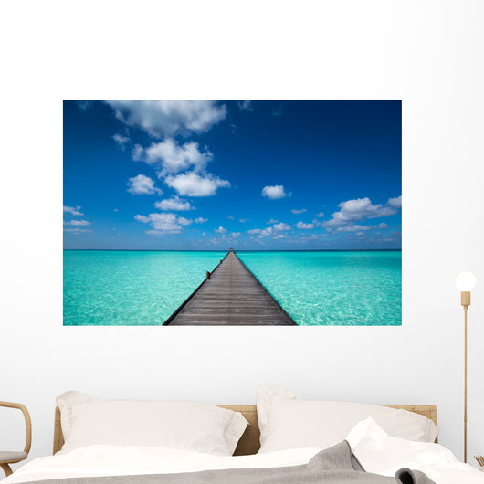 Wooden pier with blue sea and sky background Wall Decal
