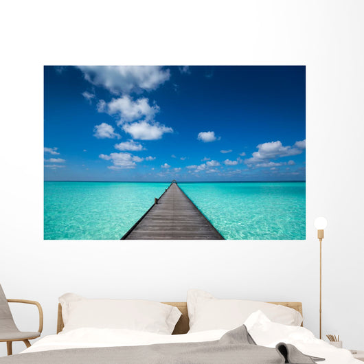 Wooden pier with blue sea and sky background Wall Decal