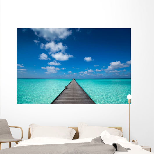 Wooden pier with blue sea and sky background Wall Decal