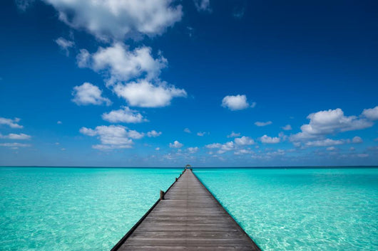 Wooden pier with blue sea and sky background Wall Decal