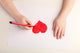 Close-up of child hands drawing a red heart Wall Decal
