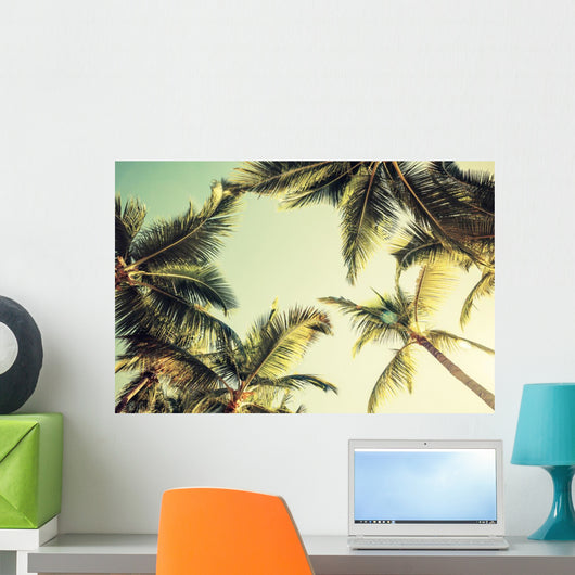 Coconut palm trees and shining sun over bright sky Wall Decal