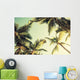 Coconut palm trees and shining sun over bright sky Wall Decal