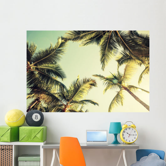 Coconut palm trees and shining sun over bright sky Wall Decal