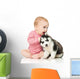 Little girl playing with a puppy husky, isolated on white Wall Decal