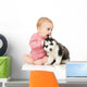 Little girl playing with a puppy husky, isolated on white Wall Decal