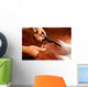 Tailor cutting animal skins at textile factory Wall Decal