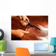 Tailor cutting animal skins at textile factory Wall Decal