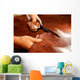 Tailor cutting animal skins at textile factory Wall Decal