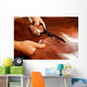 Tailor cutting animal skins at textile factory Wall Decal