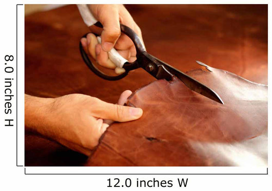 Tailor cutting animal skins at textile factory Wall Decal