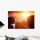 Man walking and balancing on rope over precipice in mountains Wall Decal