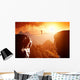 Man walking and balancing on rope over precipice in mountains Wall Decal