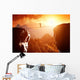 Man walking and balancing on rope over precipice in mountains Wall Decal