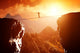 Man walking and balancing on rope over precipice in mountains Wall Decal
