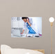 Young Woman Doctor In White Coat At Computer Using Phone Wall Decal