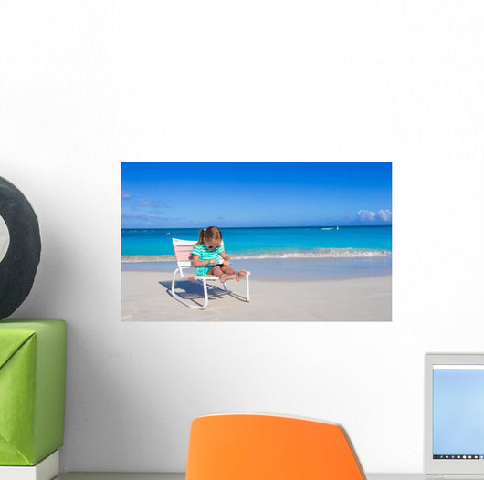 Little girl with laptop on beach during summer vacation Wall Decal