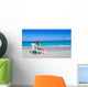 Little girl with laptop on beach during summer vacation Wall Decal