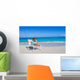 Little girl with laptop on beach during summer vacation Wall Decal
