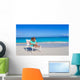 Little girl with laptop on beach during summer vacation Wall Decal