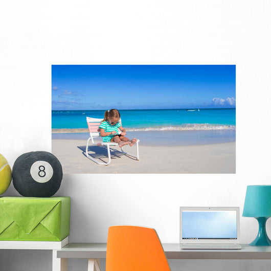 Little girl with laptop on beach during summer vacation Wall Decal