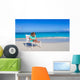 Little girl with laptop on beach during summer vacation Wall Decal