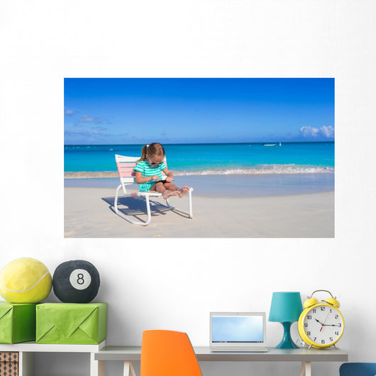 Little girl with laptop on beach during summer vacation Wall Decal