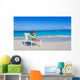 Little girl with laptop on beach during summer vacation Wall Decal