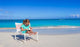 Little girl with laptop on beach during summer vacation Wall Decal