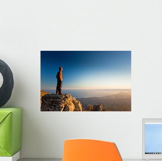 man on the cliff in mountains at sunset Wall Decal