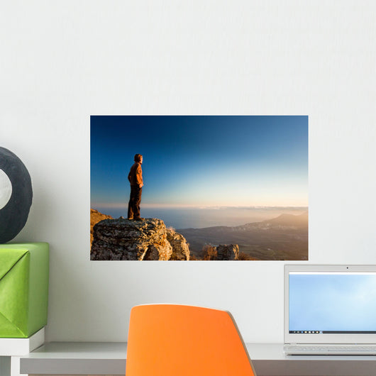 man on the cliff in mountains at sunset Wall Decal