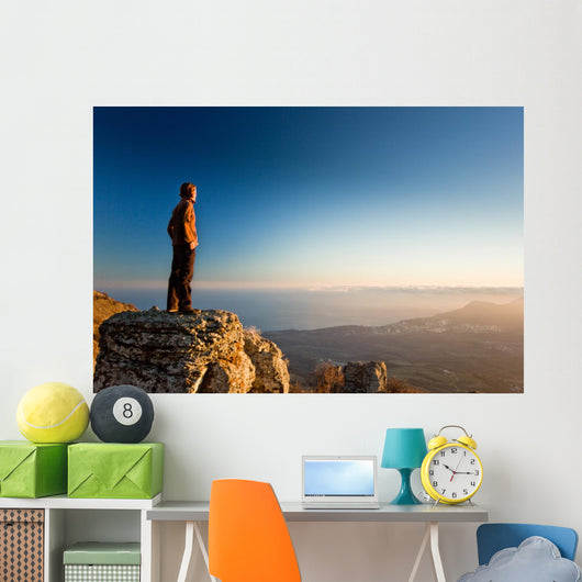 man on the cliff in mountains at sunset Wall Decal