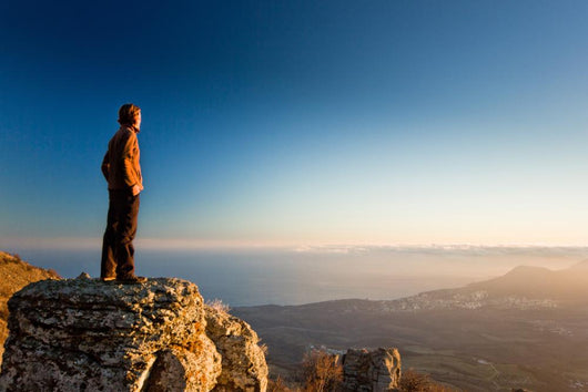 man on the cliff in mountains at sunset Wall Decal