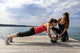 Young woman doing push-ups on a medicine ball with a coach Wall Decal