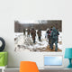 Group of hunters walking on the field in winter Wall Decal