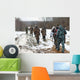 Group of hunters walking on the field in winter Wall Decal