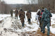 Group of hunters walking on the field in winter Wall Decal