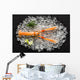 Fresh scampi shrimp on ice on a black stone table top view Wall Decal
