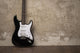 Black guitar near the wall Wall Decal