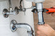 Male Plumber Fixing Sink In Bathroom Wall Decal