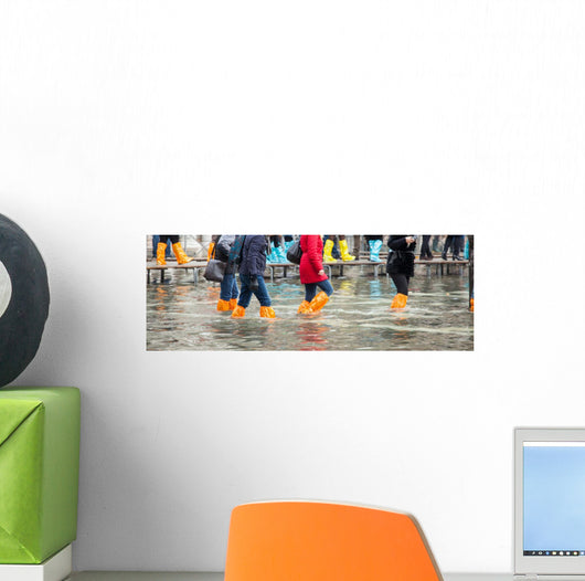 Close Up of legs with boots due to the high water in Venice. Wall Decal