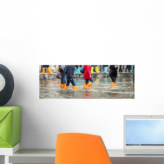 Close Up of legs with boots due to the high water in Venice. Wall Decal