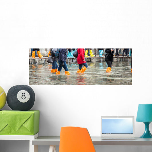 Close Up of legs with boots due to the high water in Venice. Wall Decal
